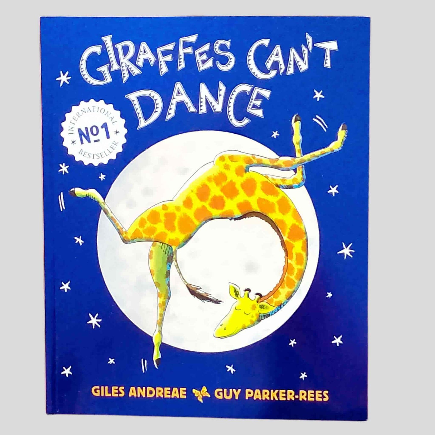 Cover of the children's book "Giraffes Can't Dance" by Giles Andreae and Guy Parker-Rees, featuring a dancing giraffe against a moonlit sky