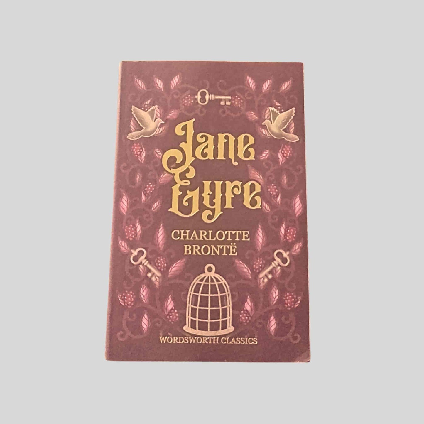 Book cover of 'Jane Eyre' by Charlotte Bronte with decorative elements on a gray background