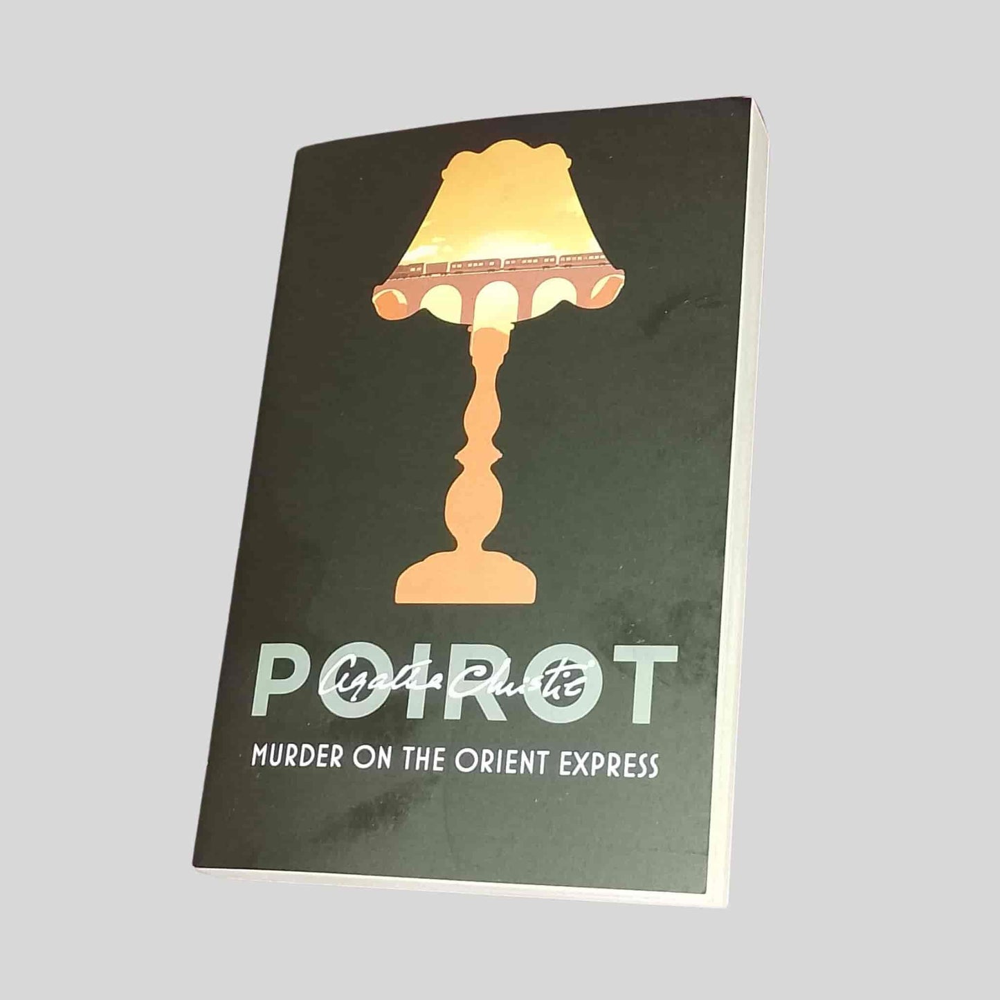 Murder on the Orient Express by Agatha Christie – modern Poirot paperback edition with lamp and train design