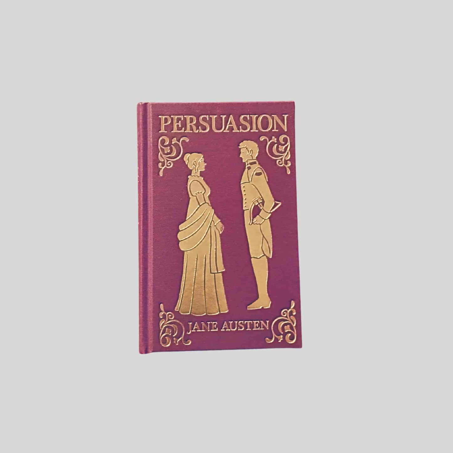 Hardback edition of Persuasion by Jane Austen with gold embossed Regency figures on a burgundy cover - TAWPublishing.co.uk
