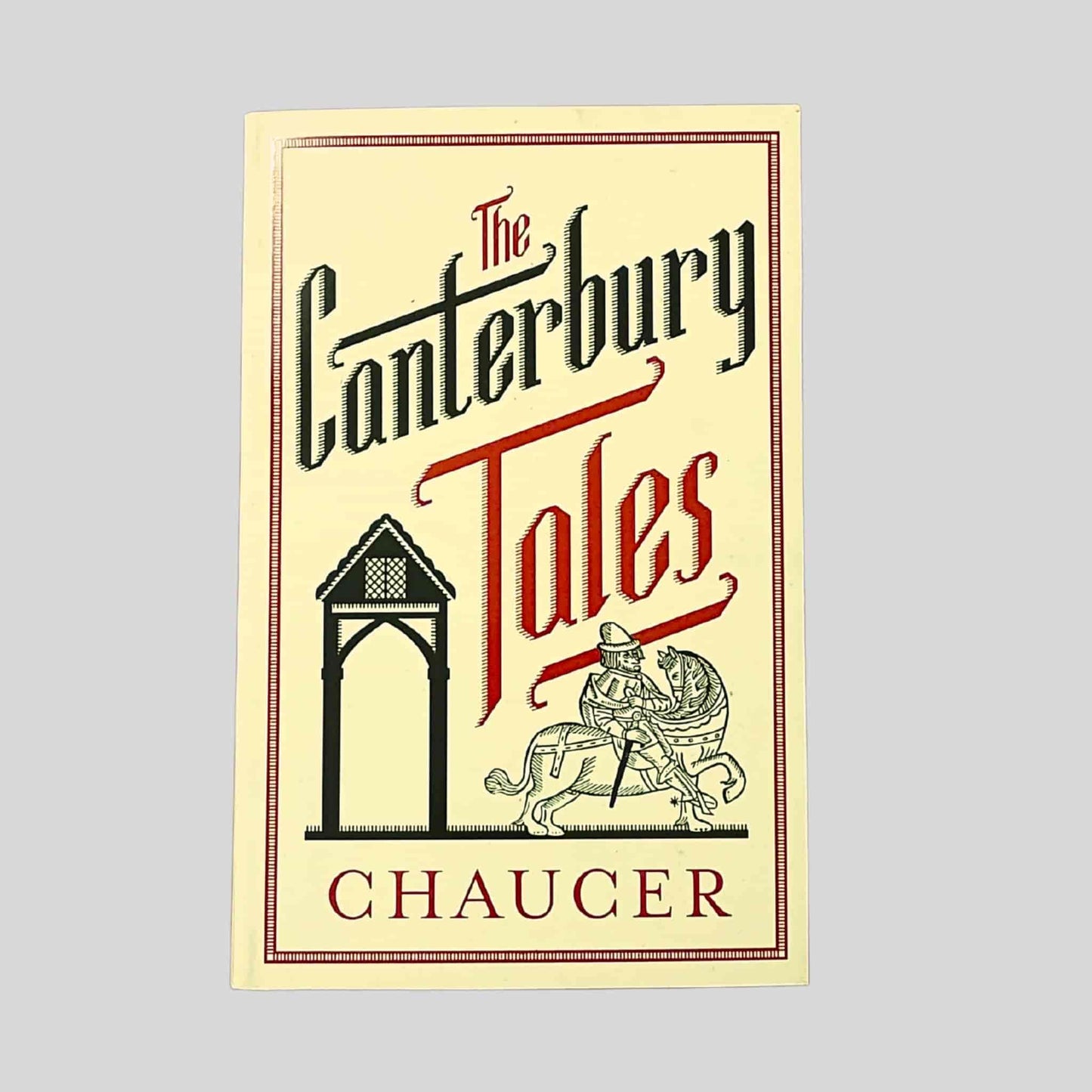 Paperback cover of The Canterbury Tales by Geoffrey Chaucer, featuring medieval-style lettering and an illustrated pilgrim scene in a decorative frame