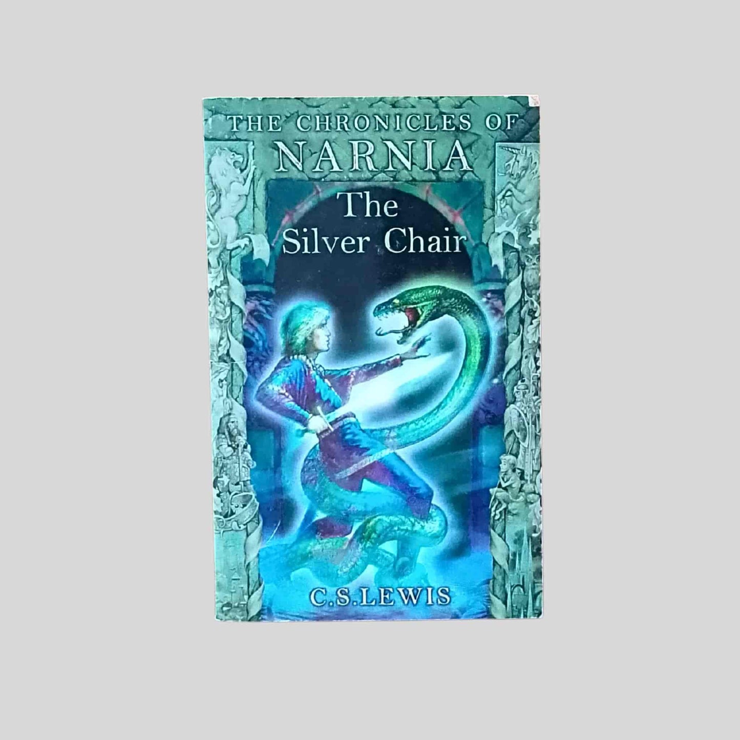 The front cover of The book Silver Chair by C. S. Lewis, showing a young hero confronting a green serpent in a glowing scene from The Chronicles of Narnia