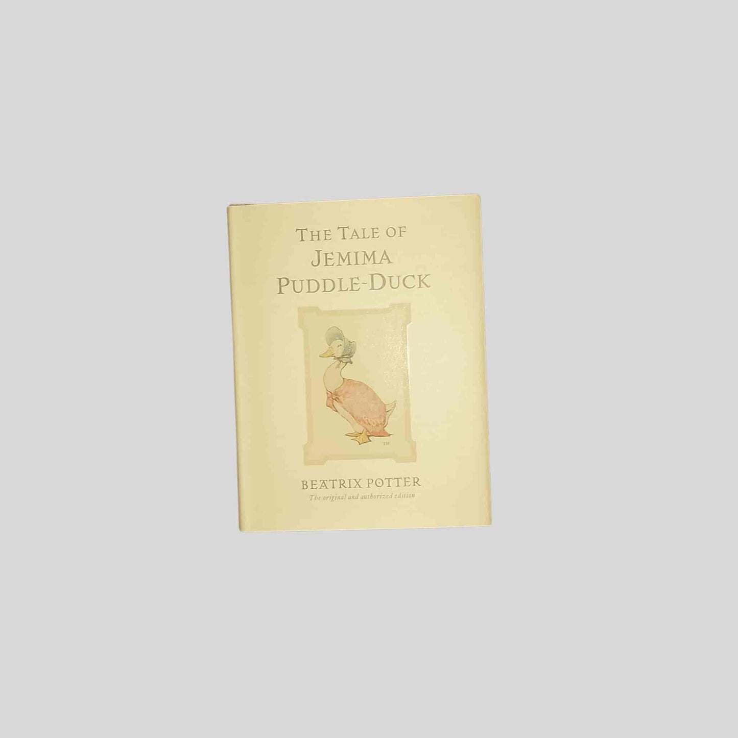 Front cover of the kids book 'The Tale of Jemima Puddle-Duck' by Beatrix Potter on a light grey background