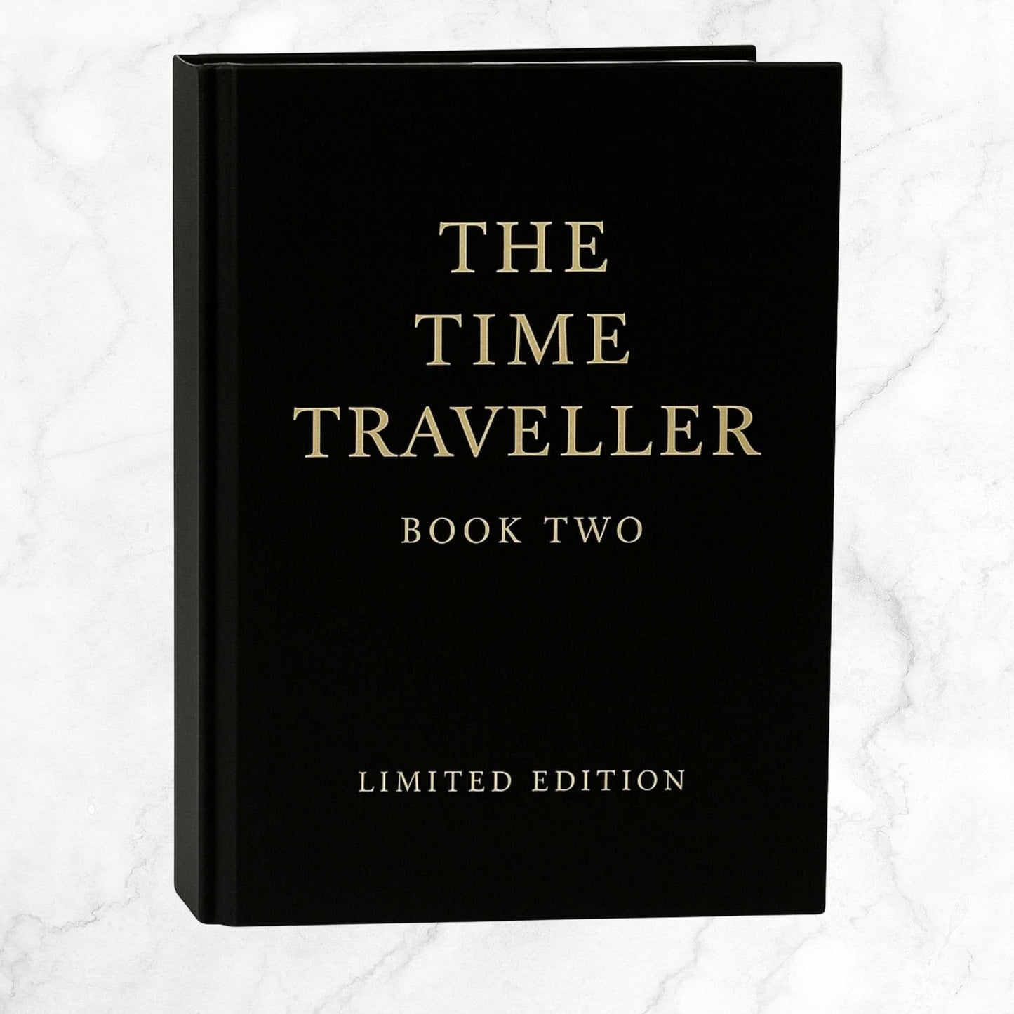 The Time Traveller Book Two limited edition hardcover, featuring gold serif lettering on a black cover, standing upright against a light background.