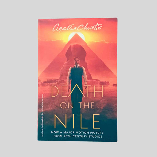 Book cover of Death on the Nile by Agatha Christie – features a man standing before the Great Sphinx and pyramid at sunset, promoting the 20th Century Studios major motion picture adaptation