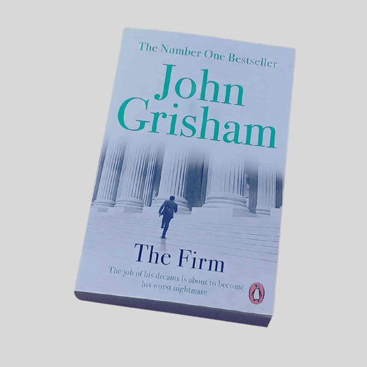 Paperback edition of John Grisham’s legal thriller The Firm showing courthouse columns and a man walking toward them - product image for TAWPublishing.co.uk
