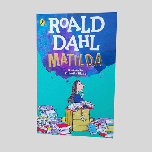 The cover of the kids book 'Matilda' by Roald Dahl with a colourful cartoon design of a girl with lots of books 