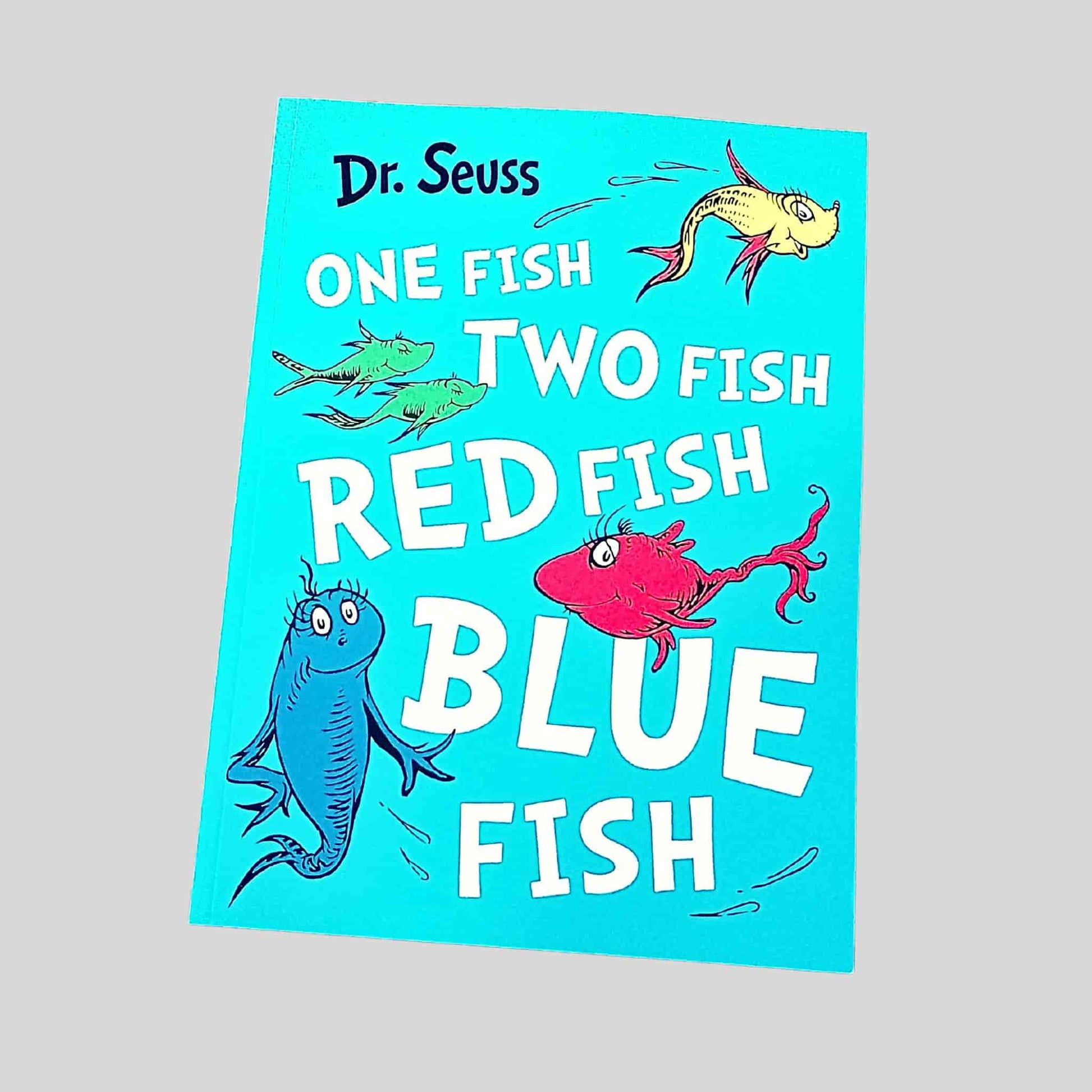 Front cover of One Fish Two Fish Red Fish Blue Fish by Dr. Seuss, featuring colourful illustrated fish on a bright turquoise background