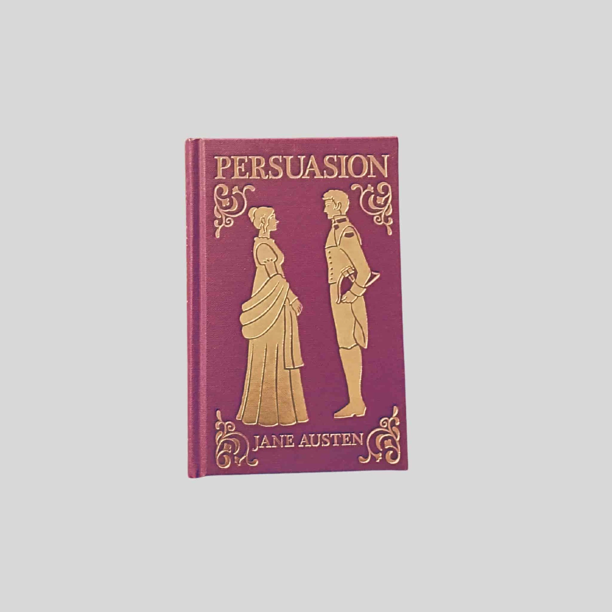 Hardback edition of Persuasion by Jane Austen with gold embossed Regency figures on a burgundy cover - TAWPublishing.co.uk
