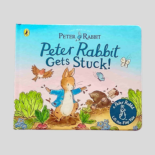 Front cover of the book Peter Rabbit Gets Stuck! – Peter Rabbit in a vegetable garden, surrounded by a mole, birds, butterflies and greenery