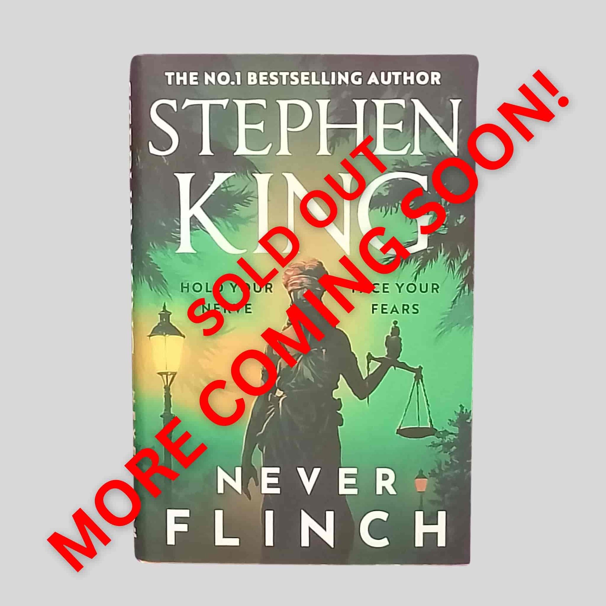 Never Flinch by Stephen King – Thriller hardback book featuring the statue of justice under a green and gold sky