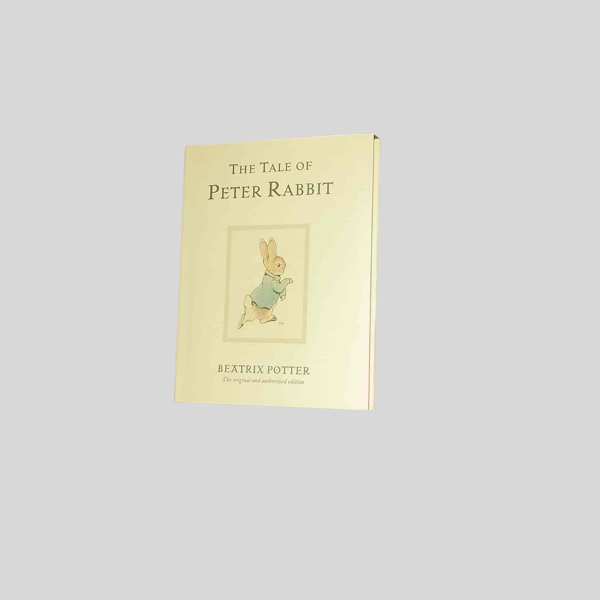 The front cover of the kids book The Tale of Peter Rabbit by Beatrix Potter – a cream cover featuring Peter in a blue jacket
