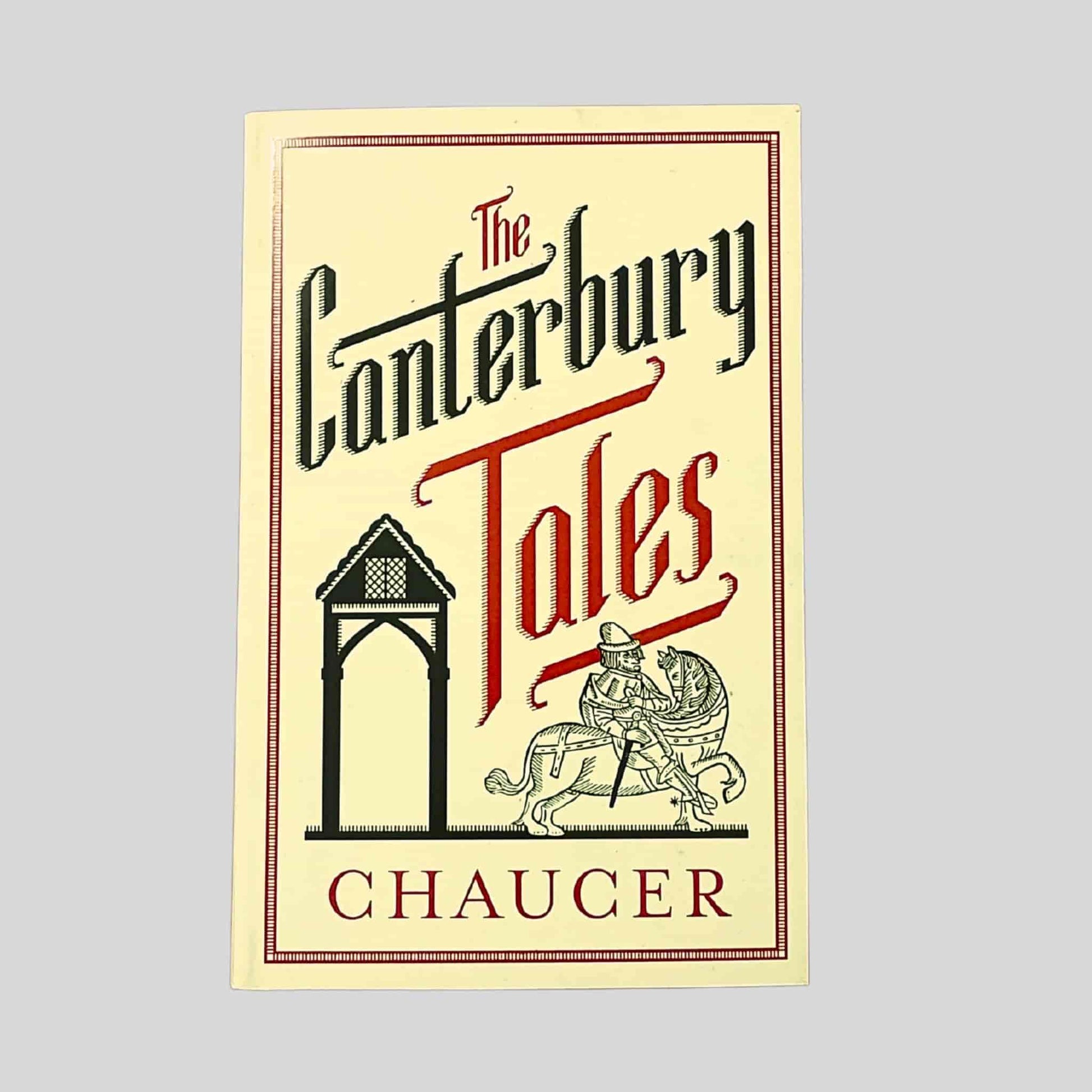 Paperback cover of The Canterbury Tales by Geoffrey Chaucer, featuring medieval-style lettering and an illustrated pilgrim scene in a decorative frame
