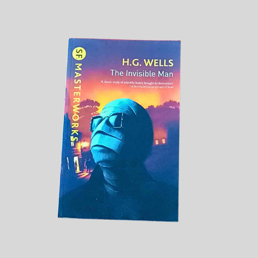 A paperback edition of The Invisible Man by H. G. Wells from the SF Masterworks series, showing a man with a fully bandaged face and head wearing dark glasses against an orange night-time backgrounding 