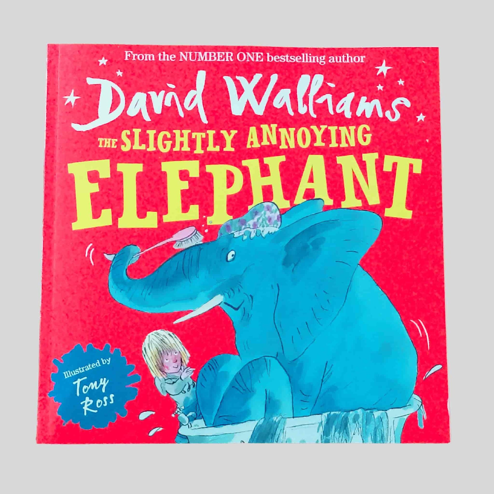 The front cover of The Slightly Annoying Elephant by David Walliams, illustrated by Tony Ross, showing a blue elephant in a bathtub with a child brushing its back