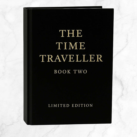 The Time Traveller Book Two limited edition hardcover, featuring gold serif lettering on a black cover, standing upright against a light background.