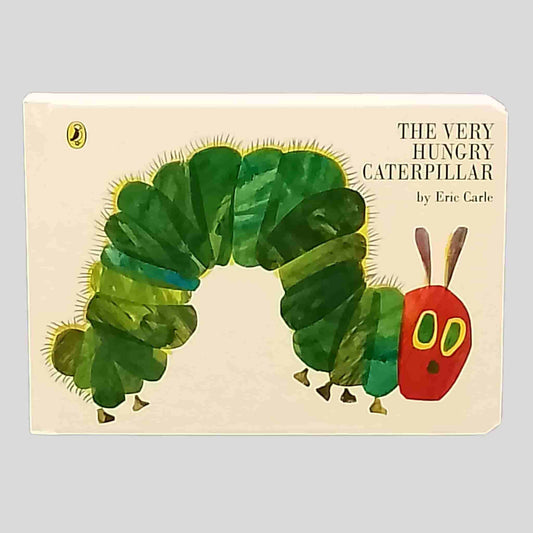 Front cover of The Very Hungry Caterpillar by Eric Carle showing the green caterpillar with red head on a cream background