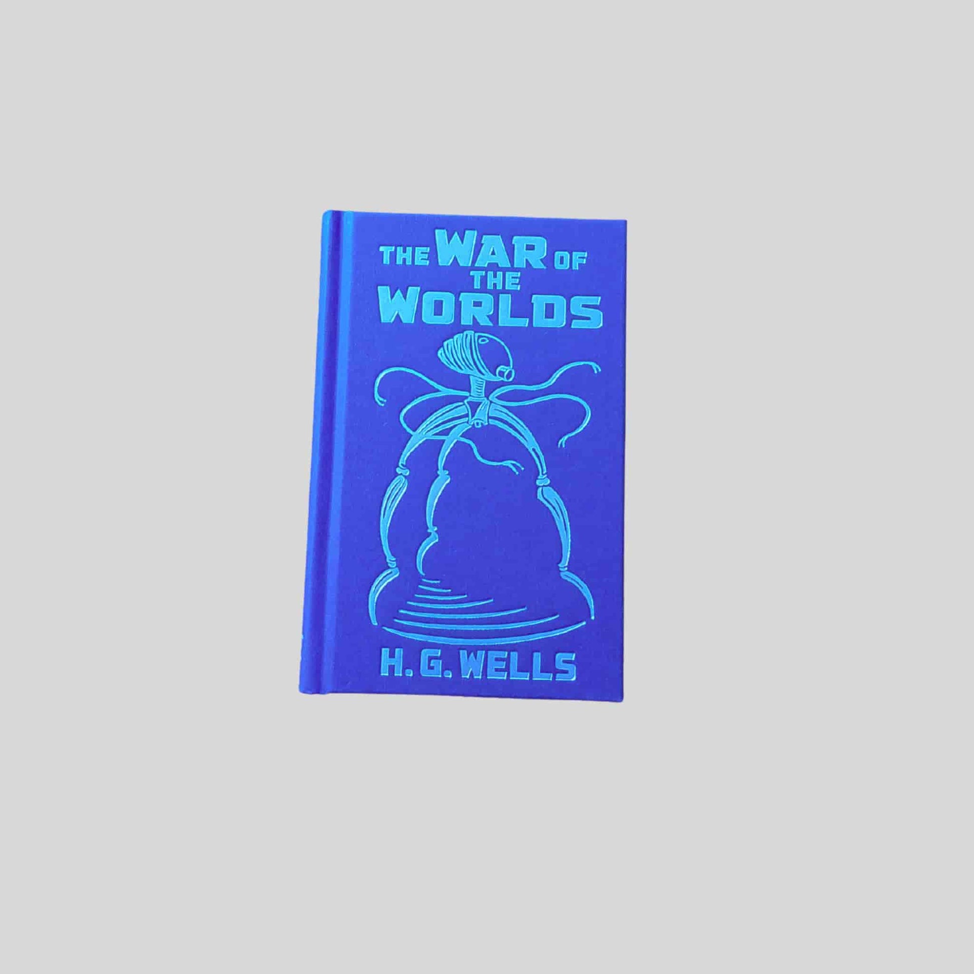 A blue hardback edition of The War of the Worlds by H. G. Wells, featuring an illustrated Martian tripod design embossed on the cover